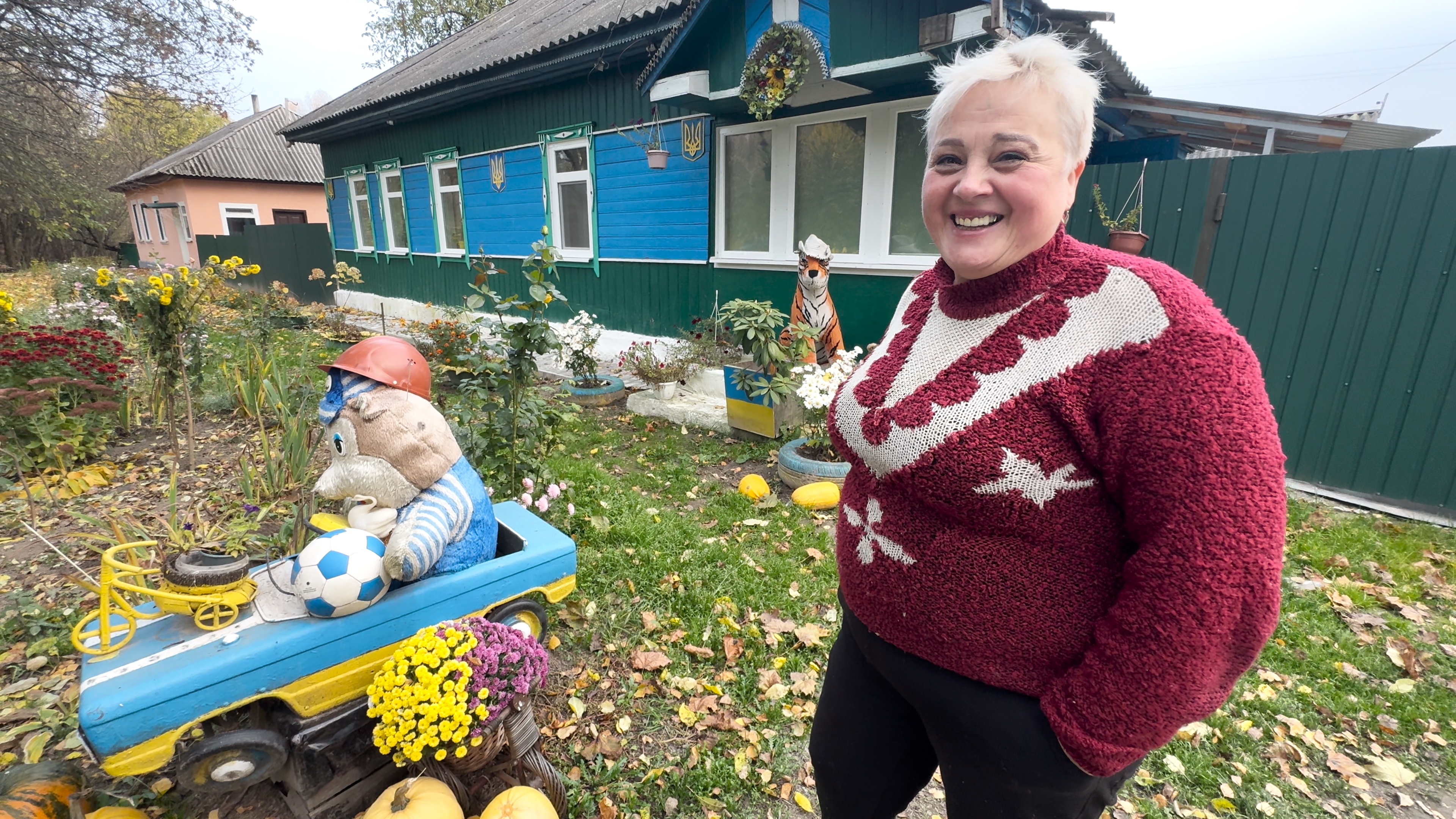 Тетяна Асланова біля будинку, який видно з траси